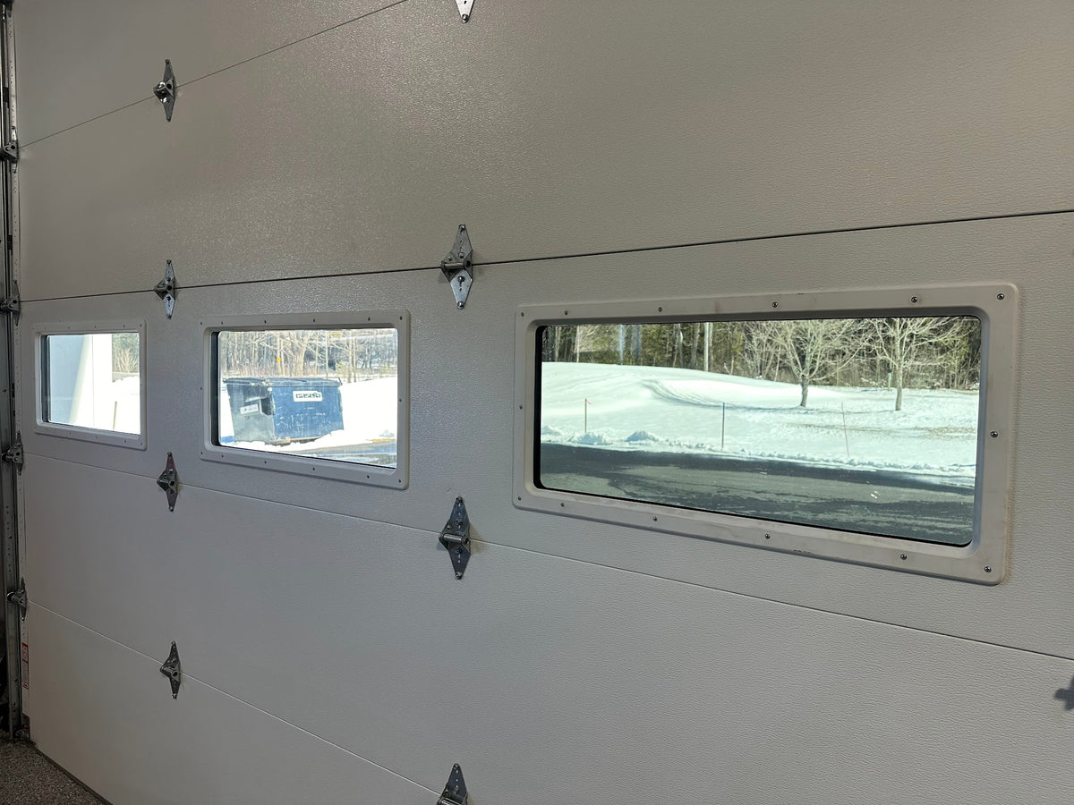 Tinted garage door windows on a home, seen from inside, installed by Granite City Graphics