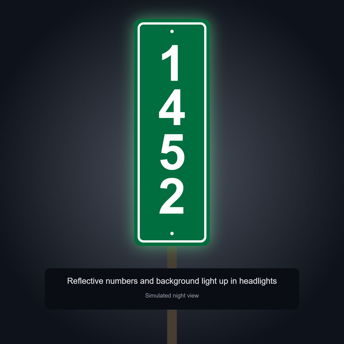 Reflective 911 address sign on a post shining in headlights at night